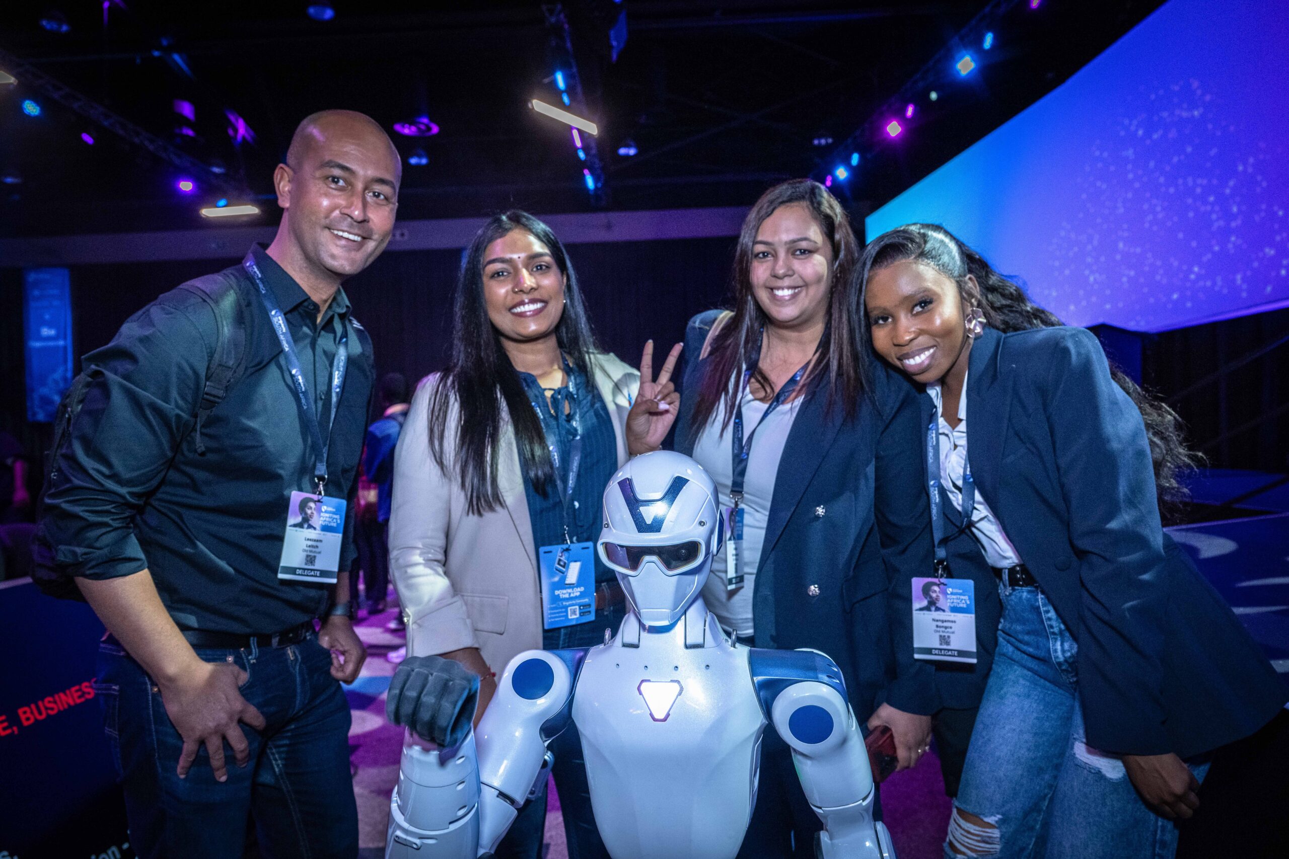 Attendees posing with a humanoid robot