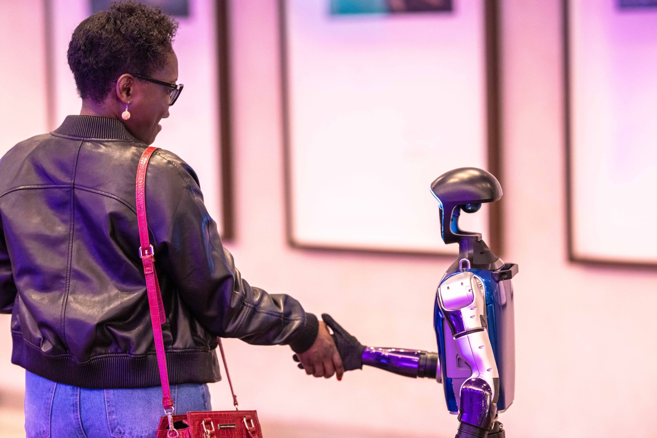 Attendee shaking hands with a humanoid robot